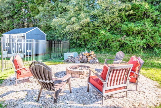 view of patio / terrace with a shed and an outdoor fire pit