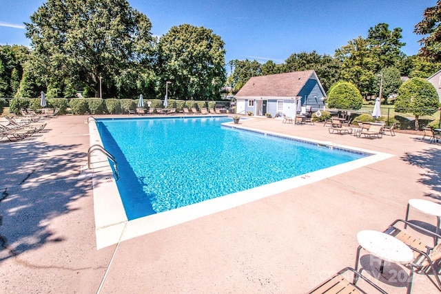 view of pool with an outdoor structure and a patio area