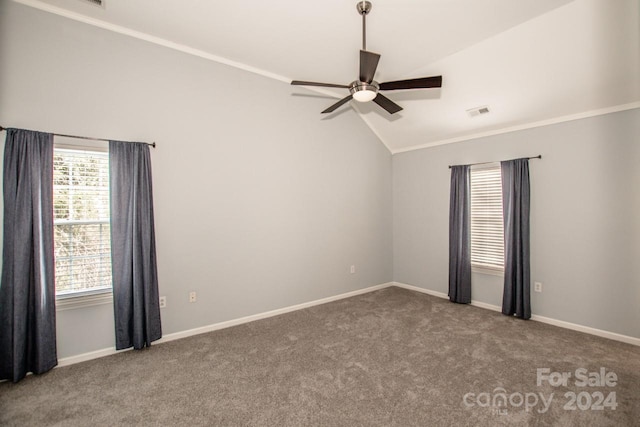 carpeted empty room with vaulted ceiling, ceiling fan, and ornamental molding