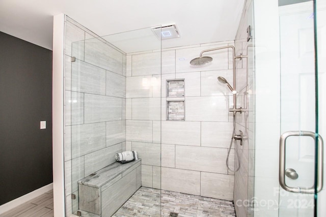 bathroom with a shower with door