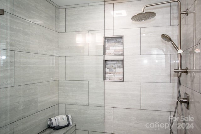 bathroom with tiled shower