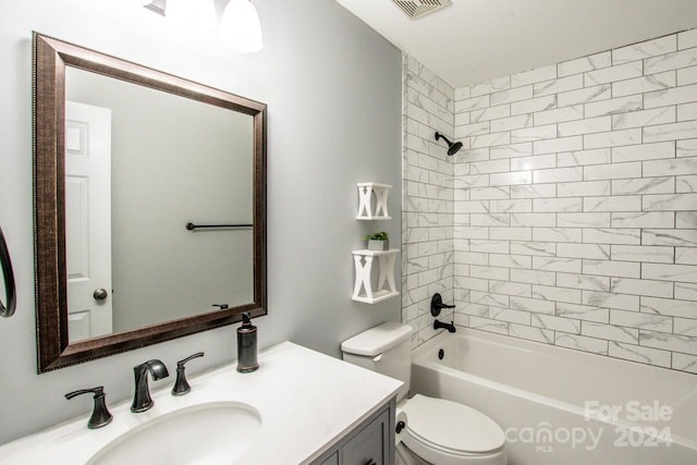 full bathroom with vanity, tiled shower / bath combo, and toilet