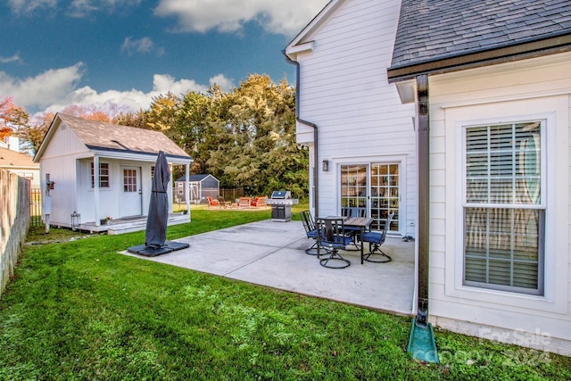 view of patio / terrace featuring an outbuilding and grilling area