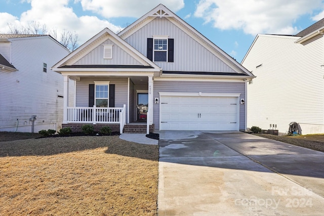 view of front of property featuring covered porch and a garage