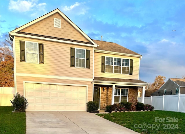 front of property featuring a front yard and a garage