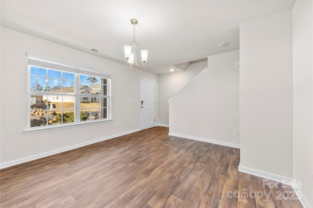 interior space with a chandelier and dark hardwood / wood-style flooring