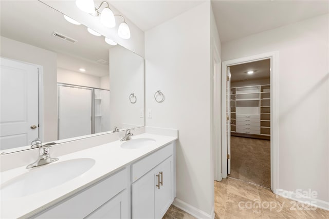 bathroom with vanity and a shower with shower door