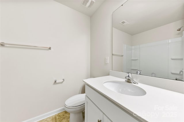 bathroom with walk in shower, vanity, and toilet