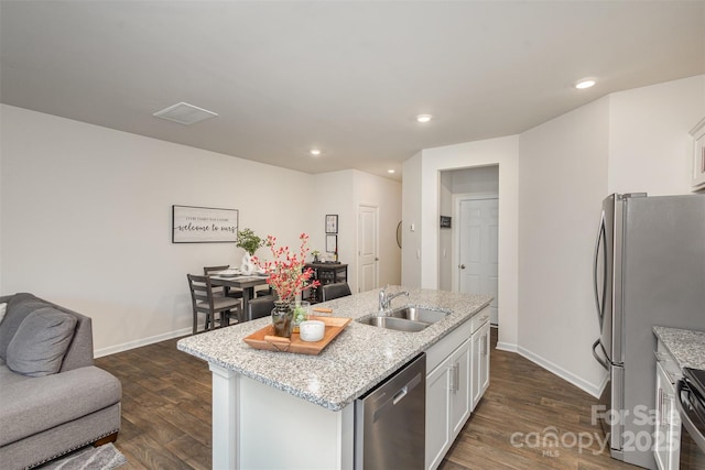 kitchen with sink, a kitchen island with sink, white cabinetry, and stainless steel appliances