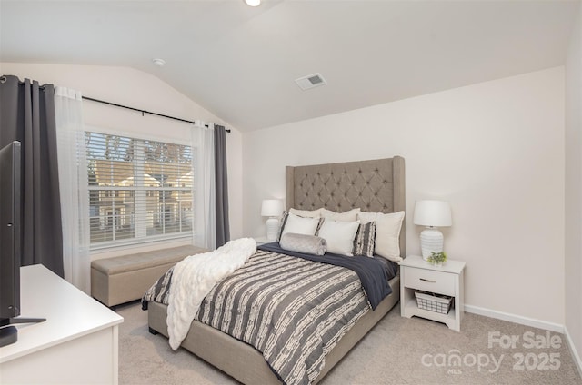 bedroom featuring vaulted ceiling and light carpet