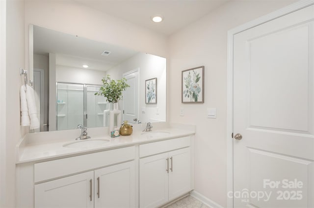 bathroom with vanity, a shower with shower door, and tile patterned flooring