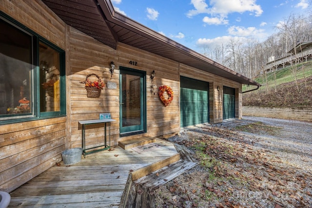 view of exterior entry with a wooden deck