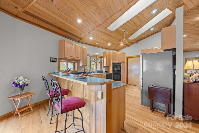 kitchen with lofted ceiling with skylight, stainless steel fridge, light hardwood / wood-style floors, kitchen peninsula, and wood ceiling