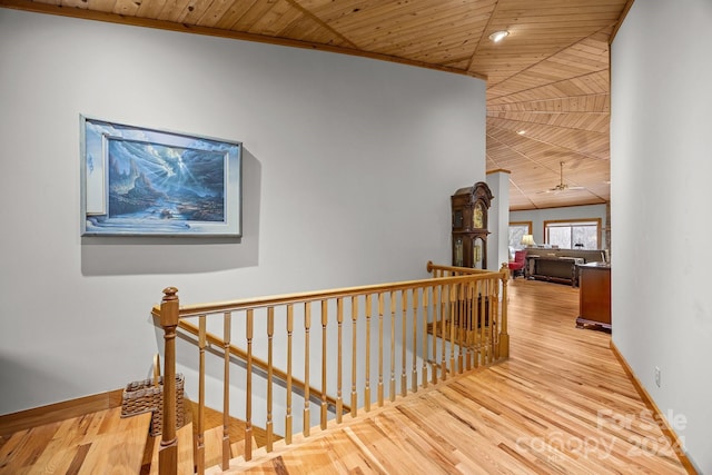 corridor featuring lofted ceiling, light hardwood / wood-style floors, and wooden ceiling