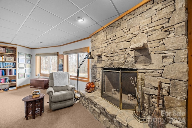 sitting room featuring carpet floors, a fireplace, and ornamental molding