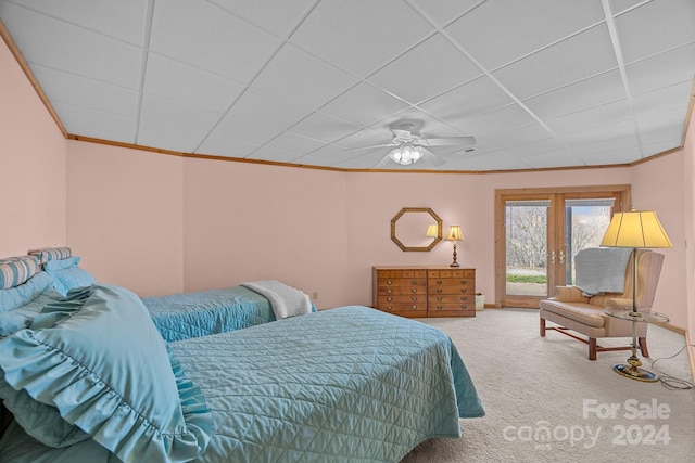 bedroom with carpet, a paneled ceiling, french doors, ceiling fan, and access to exterior