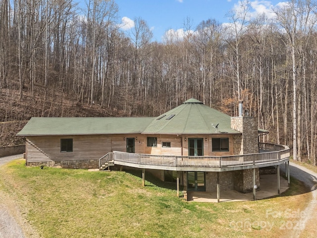 417 Quiet Forest Ln, Sylva, NC 28779 - rear view of house with french doors, a chimney, a lawn, a wooden deck, and a patio area