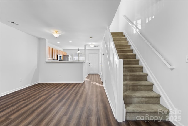 stairway featuring hardwood / wood-style floors