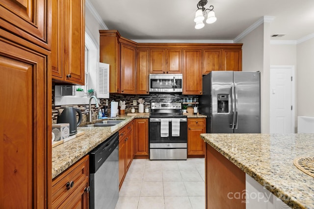 kitchen featuring light stone countertops, appliances with stainless steel finishes, tasteful backsplash, crown molding, and sink