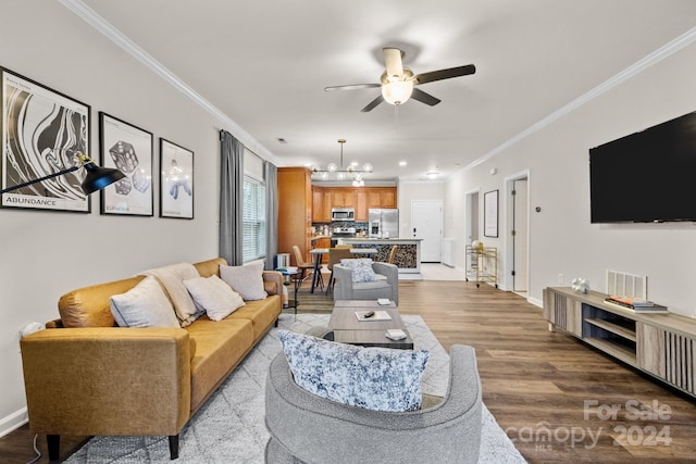 living room with ceiling fan with notable chandelier, light hardwood / wood-style floors, and crown molding