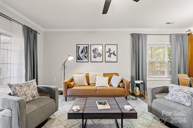 living room featuring light hardwood / wood-style floors, ceiling fan, and crown molding