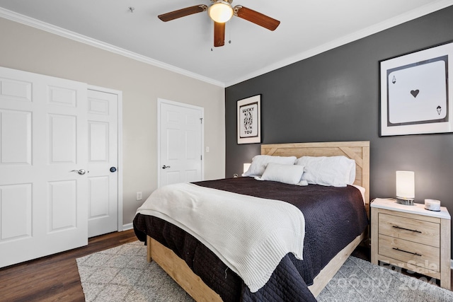 bedroom featuring ceiling fan, crown molding, and dark wood-type flooring