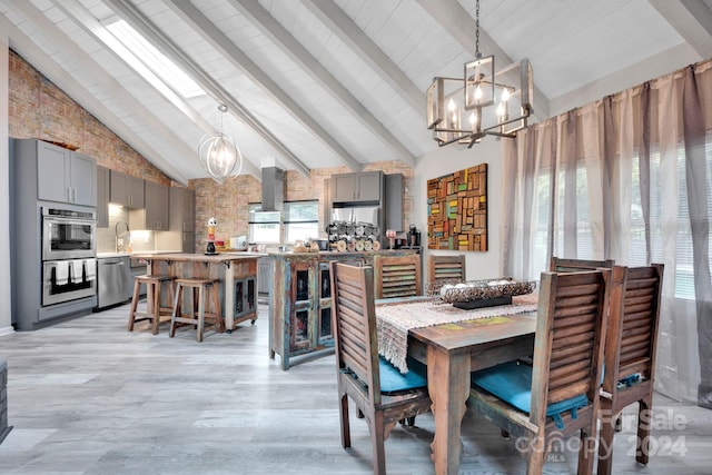 dining space featuring beamed ceiling, an inviting chandelier, high vaulted ceiling, and light hardwood / wood-style flooring