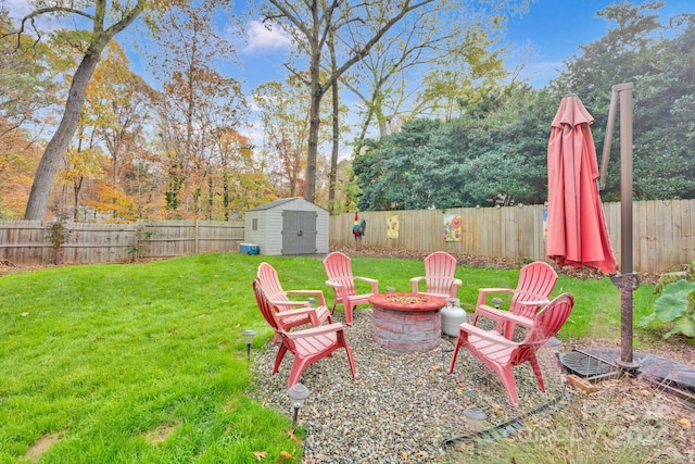 view of yard with a storage unit and an outdoor fire pit