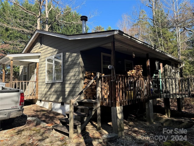 view of home's exterior with a wooden deck