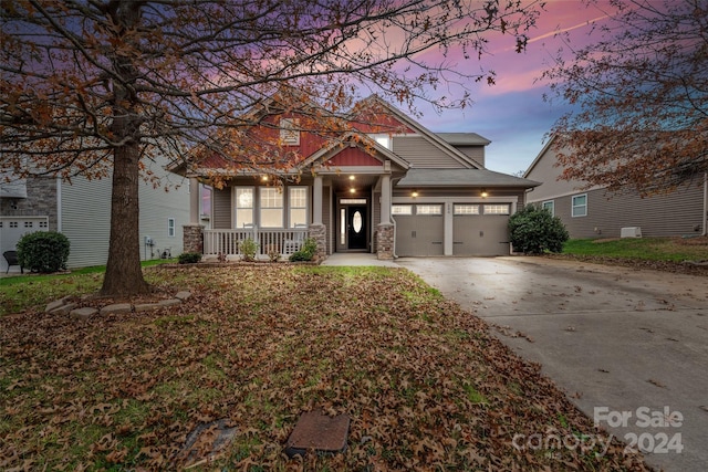 craftsman house featuring a porch and a garage