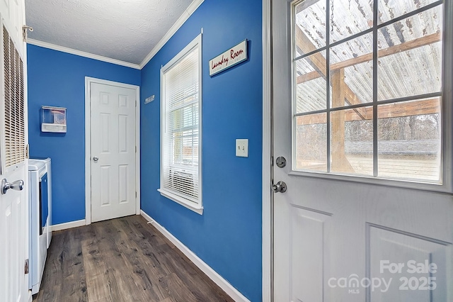 entryway featuring dark hardwood / wood-style flooring, ornamental molding, separate washer and dryer, and a textured ceiling