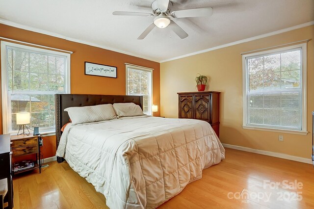 bedroom with ornamental molding, ceiling fan, and light wood-type flooring