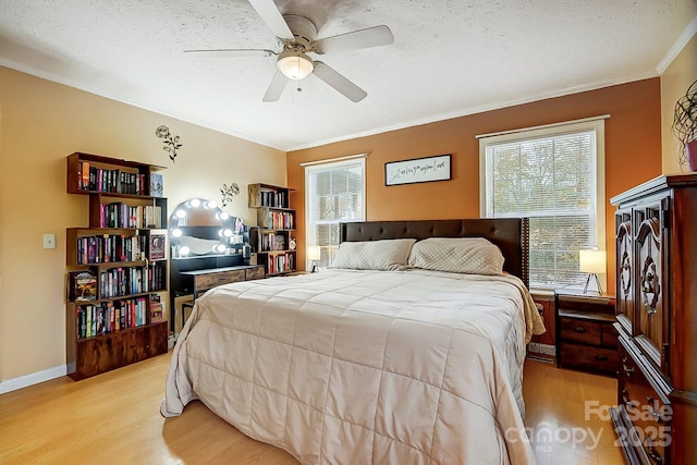 bedroom featuring multiple windows, ornamental molding, and light hardwood / wood-style flooring