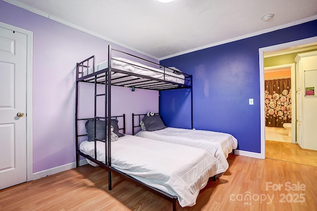 bedroom featuring hardwood / wood-style flooring and ornamental molding