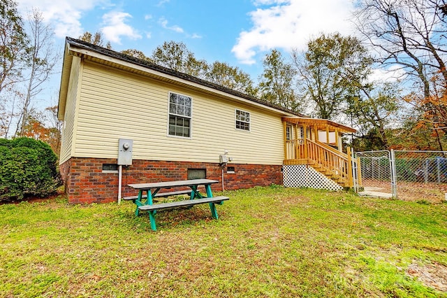 back of house with a lawn