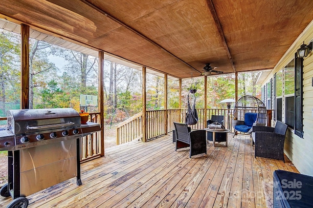 sunroom / solarium with ceiling fan and wood ceiling