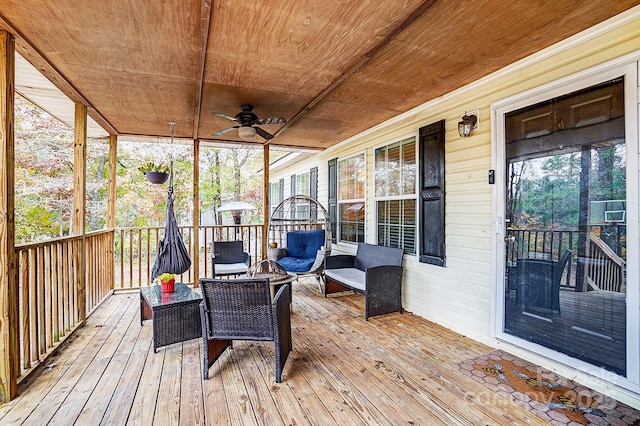 sunroom / solarium with wooden ceiling and ceiling fan