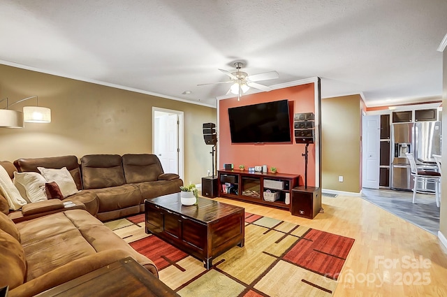 living room featuring ornamental molding, ceiling fan, and light hardwood / wood-style flooring