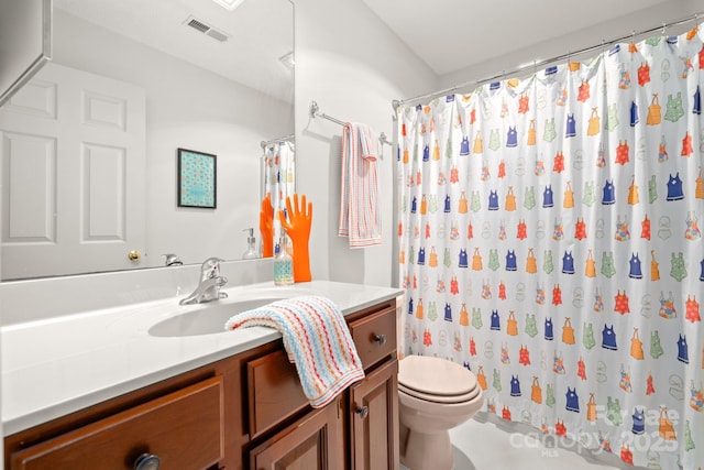 bathroom featuring vanity, toilet, and a shower with shower curtain