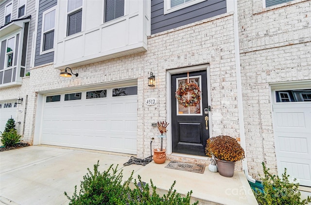 doorway to property with a garage