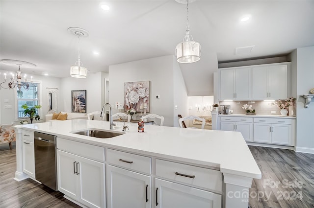 kitchen with dark hardwood / wood-style flooring, a center island with sink, white cabinets, and stainless steel dishwasher