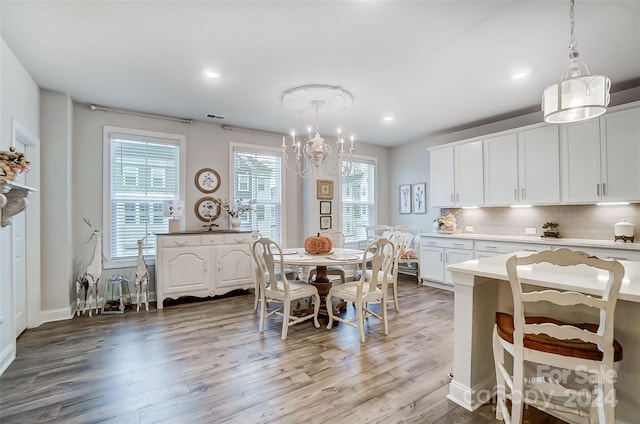 dining room with a notable chandelier and light wood-type flooring