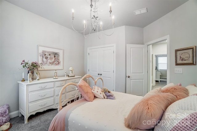 carpeted bedroom with a chandelier and a closet