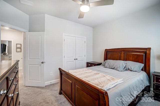 bedroom featuring ceiling fan, a closet, and light carpet