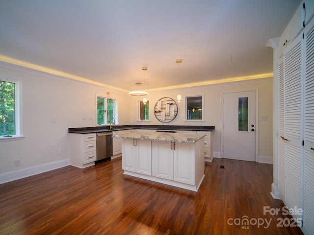 kitchen featuring white cabinets, hanging light fixtures, dishwasher, dark stone countertops, and dark wood finished floors