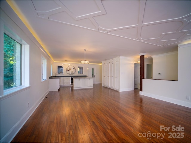 unfurnished living room with dark wood-style flooring, visible vents, and baseboards