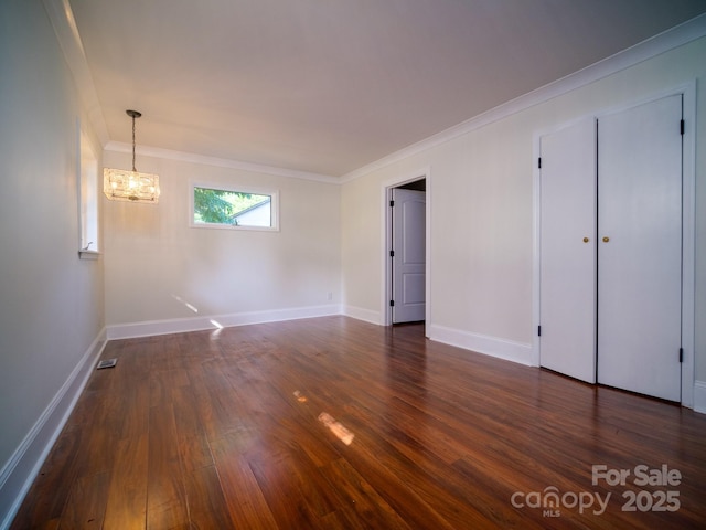 interior space with baseboards, dark wood-style flooring, and ornamental molding