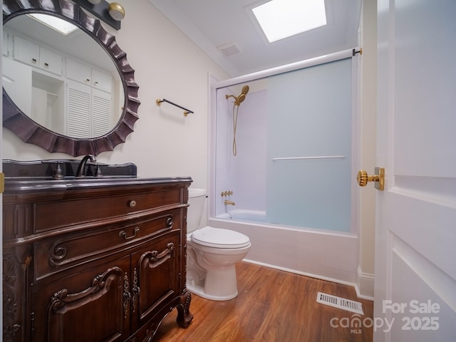 full bath featuring bathing tub / shower combination, visible vents, toilet, vanity, and wood finished floors