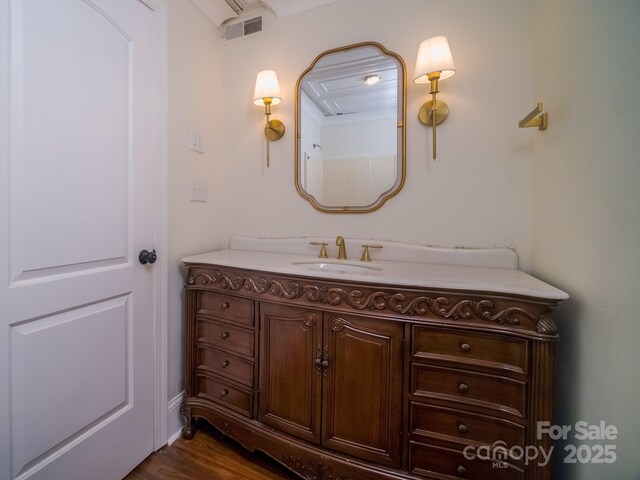 bathroom with visible vents, wood finished floors, and vanity