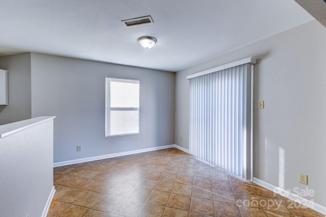 empty room featuring light tile patterned floors